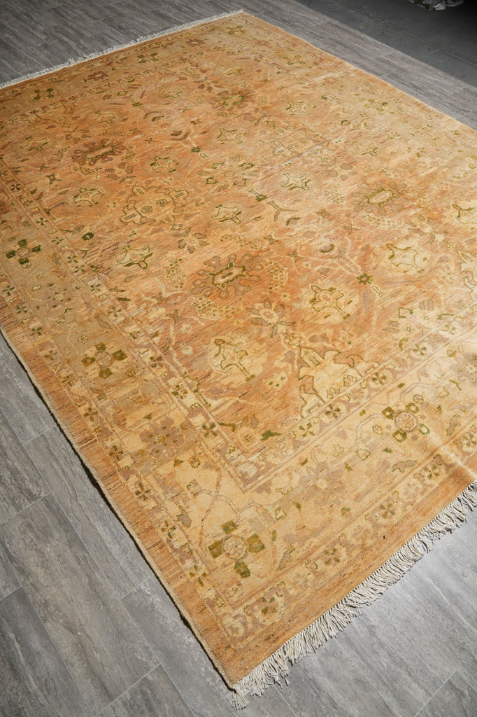 Beige patterned rug on a wooden floor