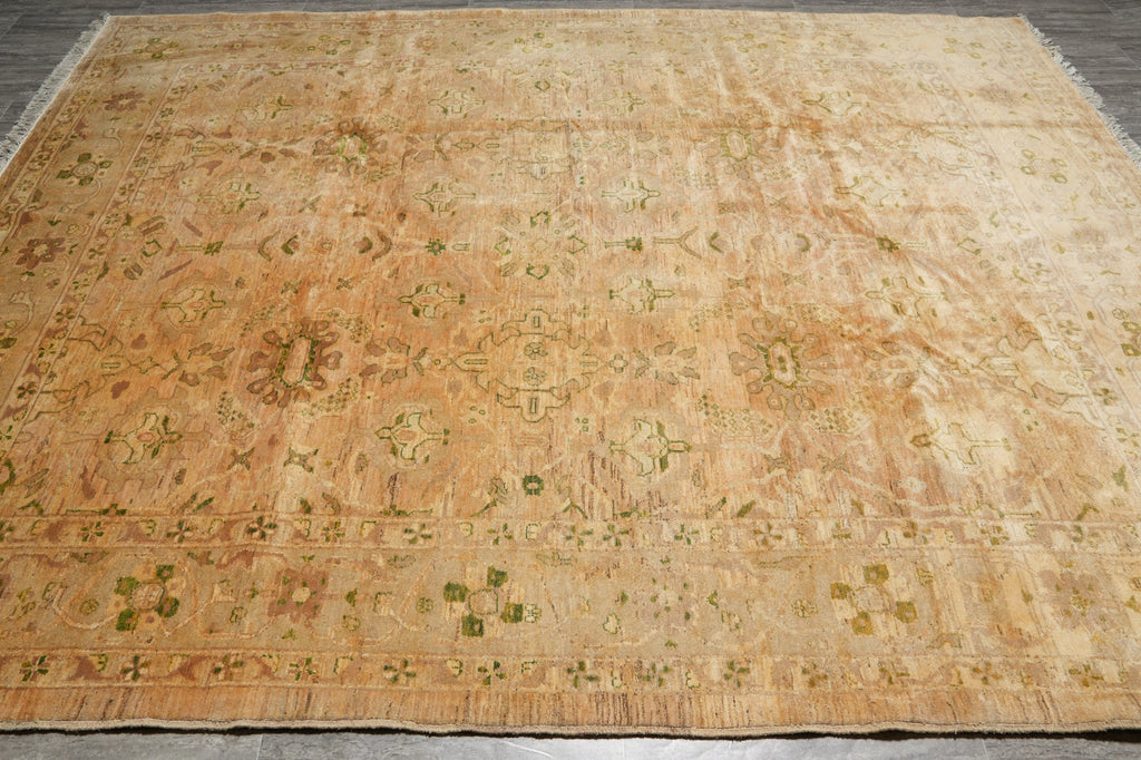 Vintage beige rug with intricate patterns on a wooden floor