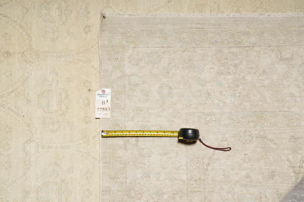 Measuring tape on a textured beige surface with a visible tag.