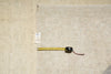 Load image into Gallery viewer, Measuring tape on a textured beige surface with a visible tag.