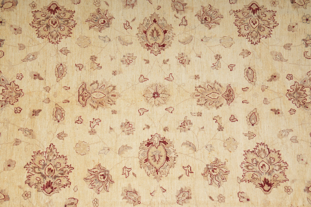 Patterned fabric with red floral and geometric designs on a beige background