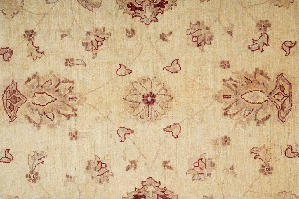 Textile with intricate red floral patterns on a beige background