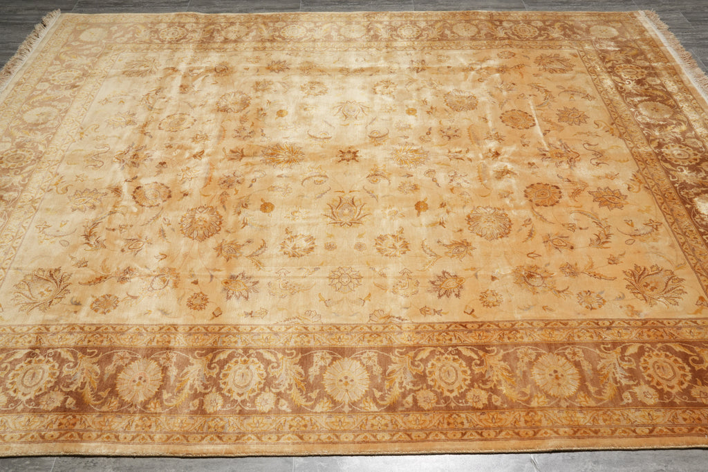 Decorative beige rug with intricate patterns on a wooden floor