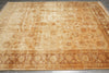 Load image into Gallery viewer, Decorative beige rug with intricate patterns on a wooden floor
