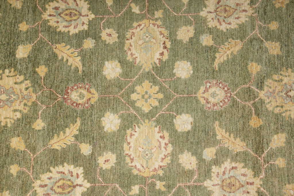 Close-up of a patterned green rug with floral designs
