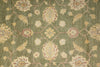 Load image into Gallery viewer, Close-up of a patterned green rug with floral designs