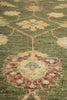 Load image into Gallery viewer, Close-up of a patterned green rug with intricate designs.