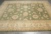Load image into Gallery viewer, Decorative green rug with floral patterns on a wooden floor