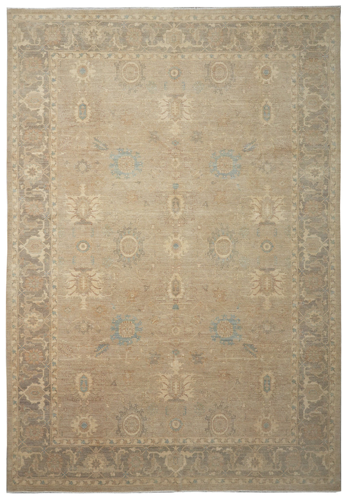 Beige area rug with intricate patterns on a plain background