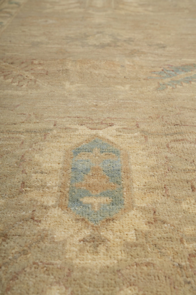 Textured beige fabric with a central blue pattern
