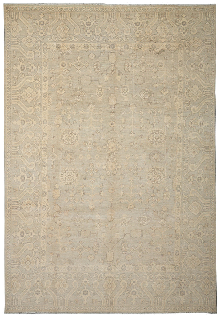 Beige area rug with intricate patterns on a plain background