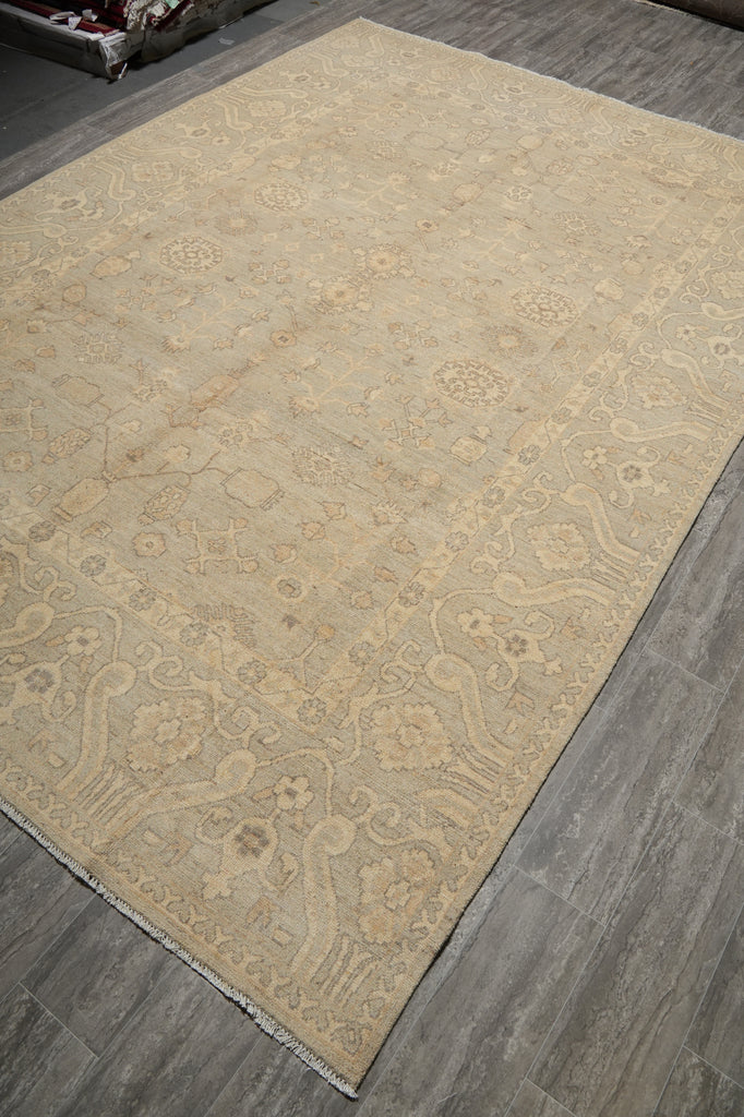 Beige patterned rug on a wooden floor
