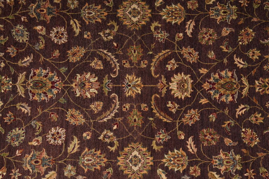 Close-up of a patterned rug with intricate designs on a brown background