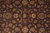 Load image into Gallery viewer, Close-up of a patterned rug with intricate designs on a brown background
