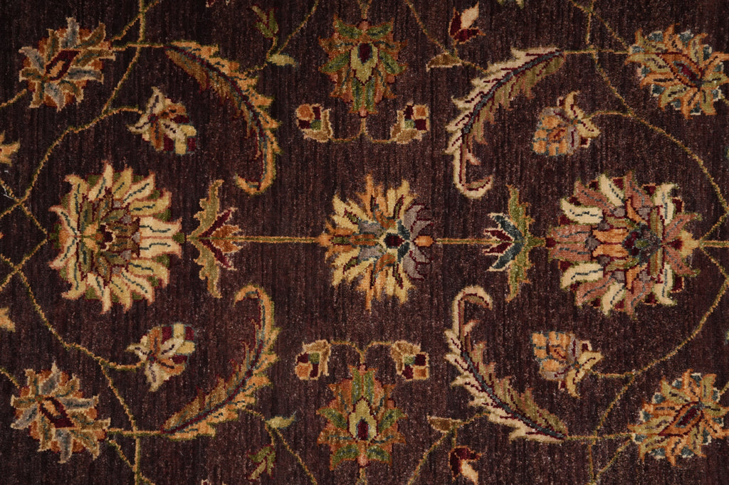 Close-up of a patterned rug with floral designs on a dark brown background