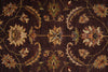 Load image into Gallery viewer, Close-up of a patterned rug with floral designs on a dark brown background