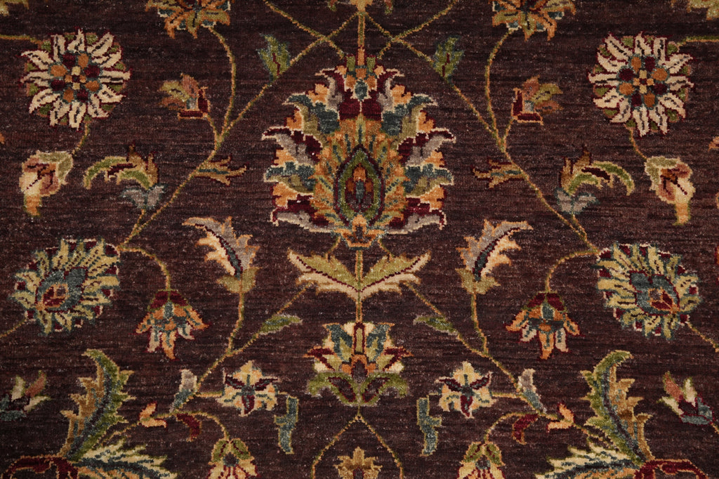 Close-up of a patterned rug with floral designs on a dark brown background