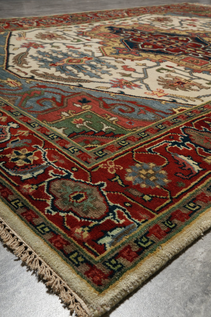 Close-up of a patterned rug with intricate designs on a metallic surface.