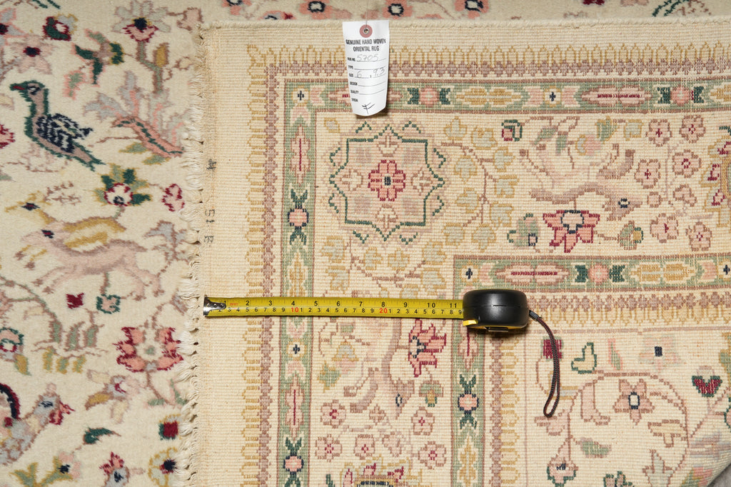 Decorative rug with intricate patterns and a measuring tape on top