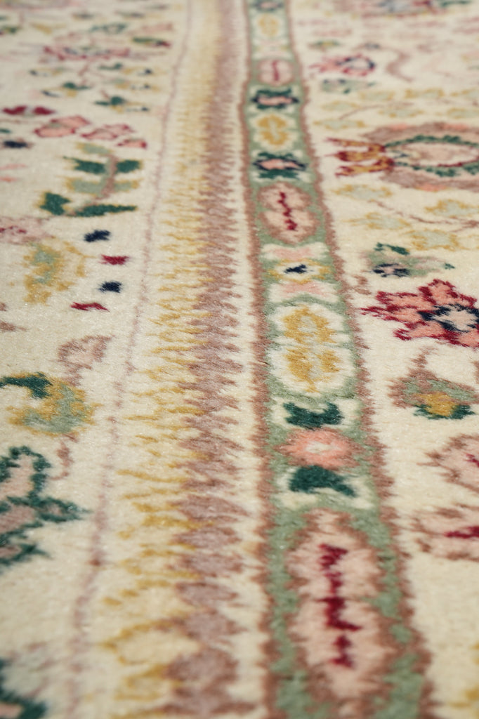 Close-up of a patterned fabric with floral and geometric designs.