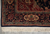 Load image into Gallery viewer, Close-up of a patterned rug with intricate designs on a gray floor.