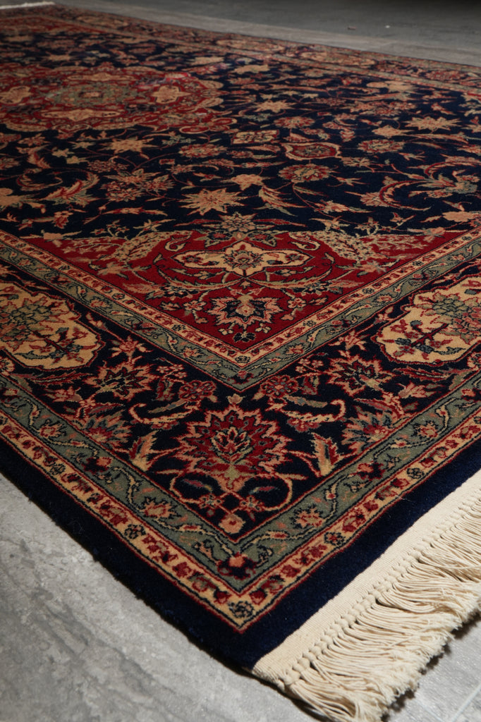 Decorative rug with intricate patterns on a gray floor