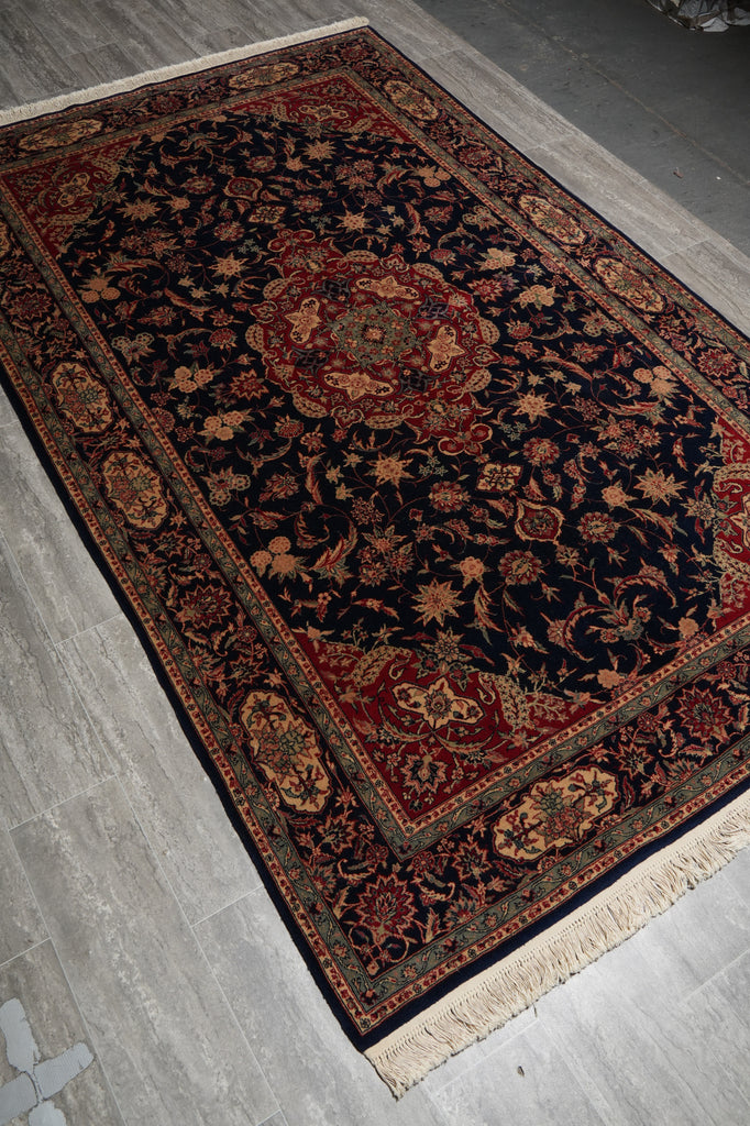 Decorative rug with intricate patterns on a gray floor