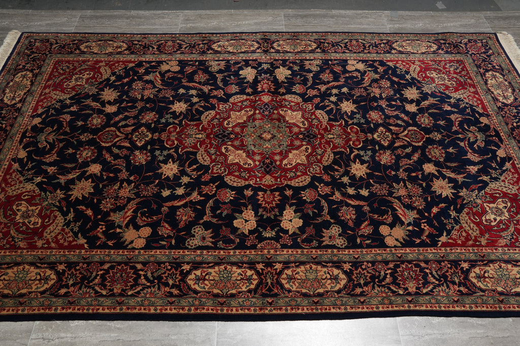 Decorative rug with intricate patterns on a wooden floor