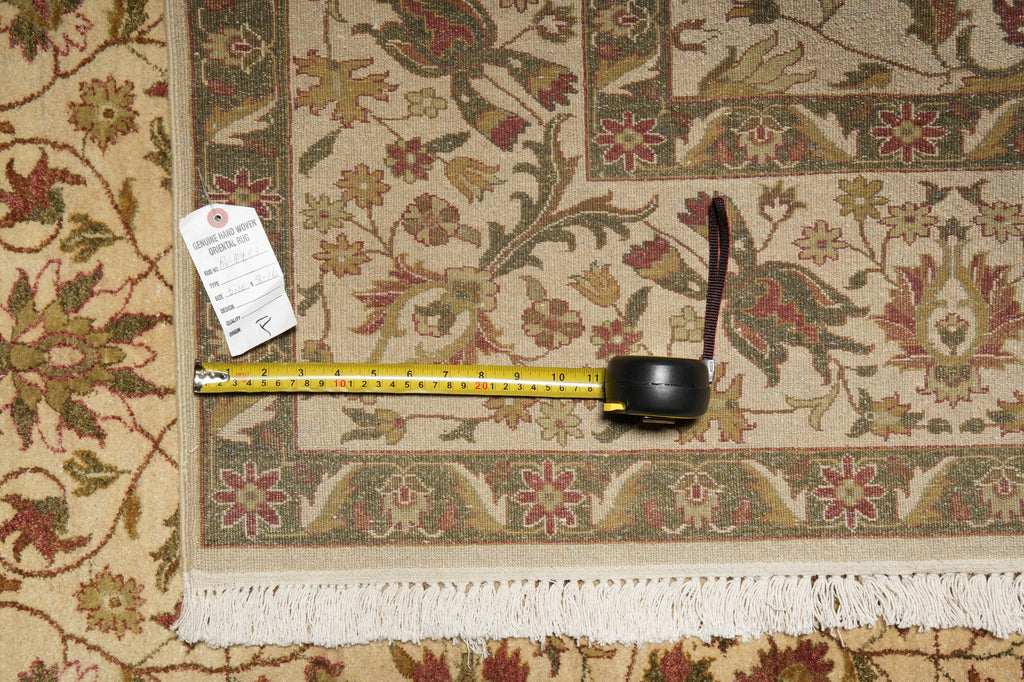 Decorative rug with a measuring tape and pen on top, showing floral patterns.