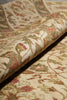 Load image into Gallery viewer, Close-up of a patterned fabric with intricate designs in red, green, and beige.