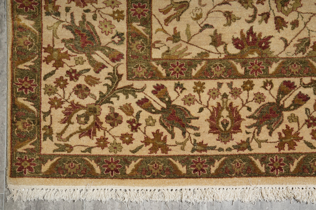 Close-up of an intricately designed rug with floral patterns on a neutral background