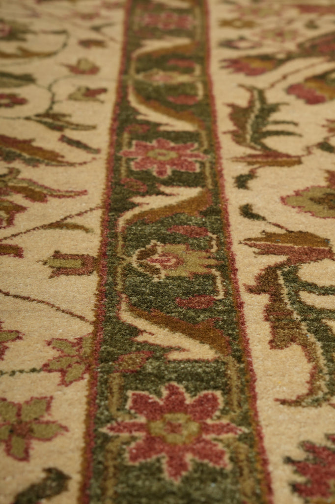 Close-up of an intricately designed floral patterned rug with a focus on a decorative border.