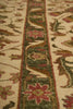 Load image into Gallery viewer, Close-up of an intricately designed floral patterned rug with a focus on a decorative border.