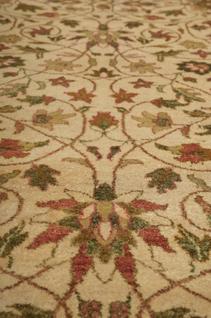Close-up of a patterned rug with floral designs on a beige background