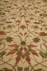 Load image into Gallery viewer, Close-up of a patterned rug with floral designs on a beige background