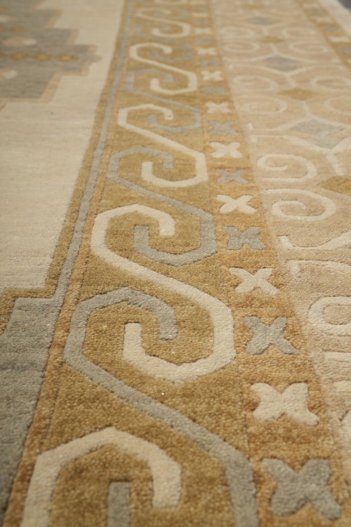 Close-up of a patterned beige and brown rug