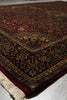 Load image into Gallery viewer, Close-up of an intricately patterned rug with visible fringe on a neutral background