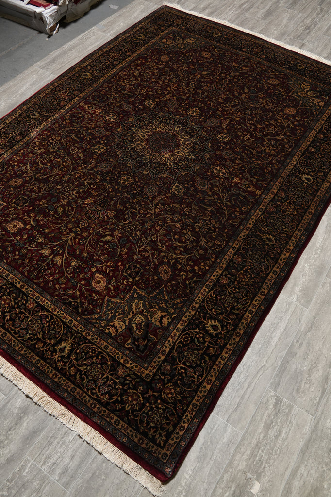 Dark brown patterned rug on a wooden floor