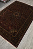Load image into Gallery viewer, Dark brown patterned rug on a wooden floor
