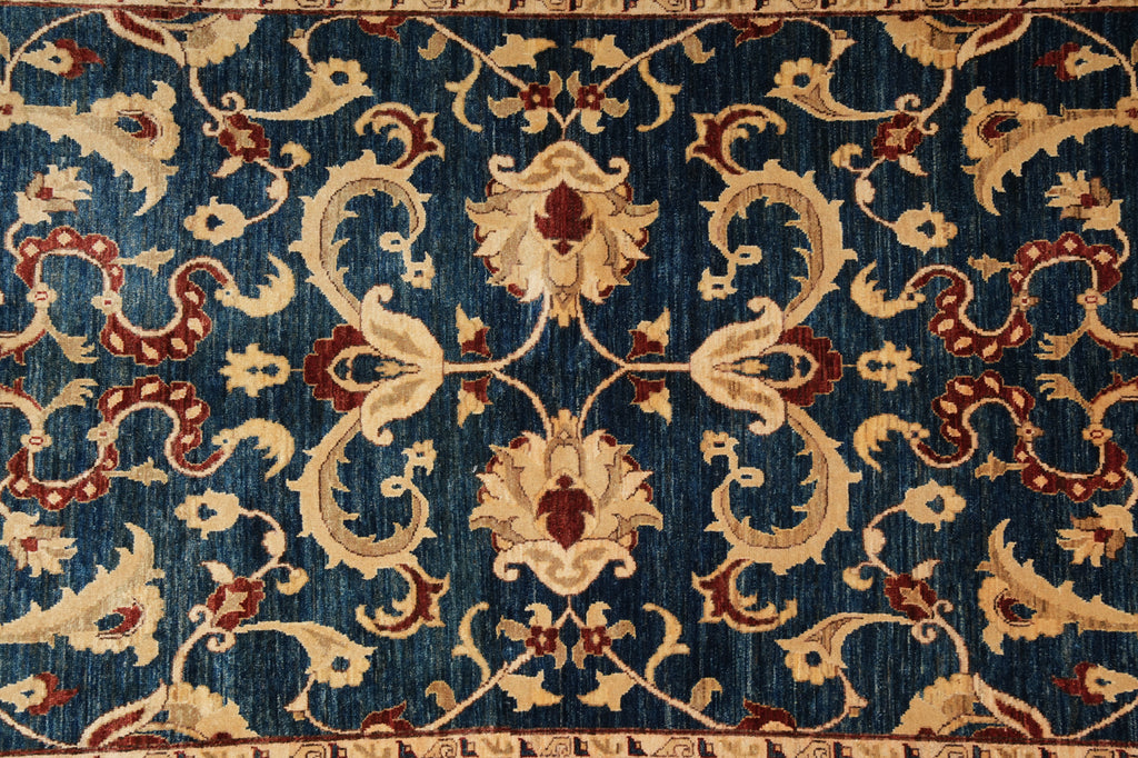 Close-up of an ornate rug with intricate patterns on a blue background