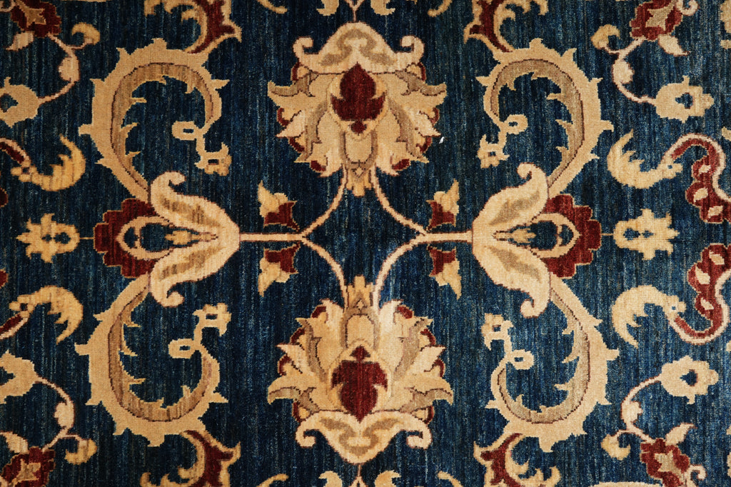 Close-up of a patterned rug with intricate designs on a blue background