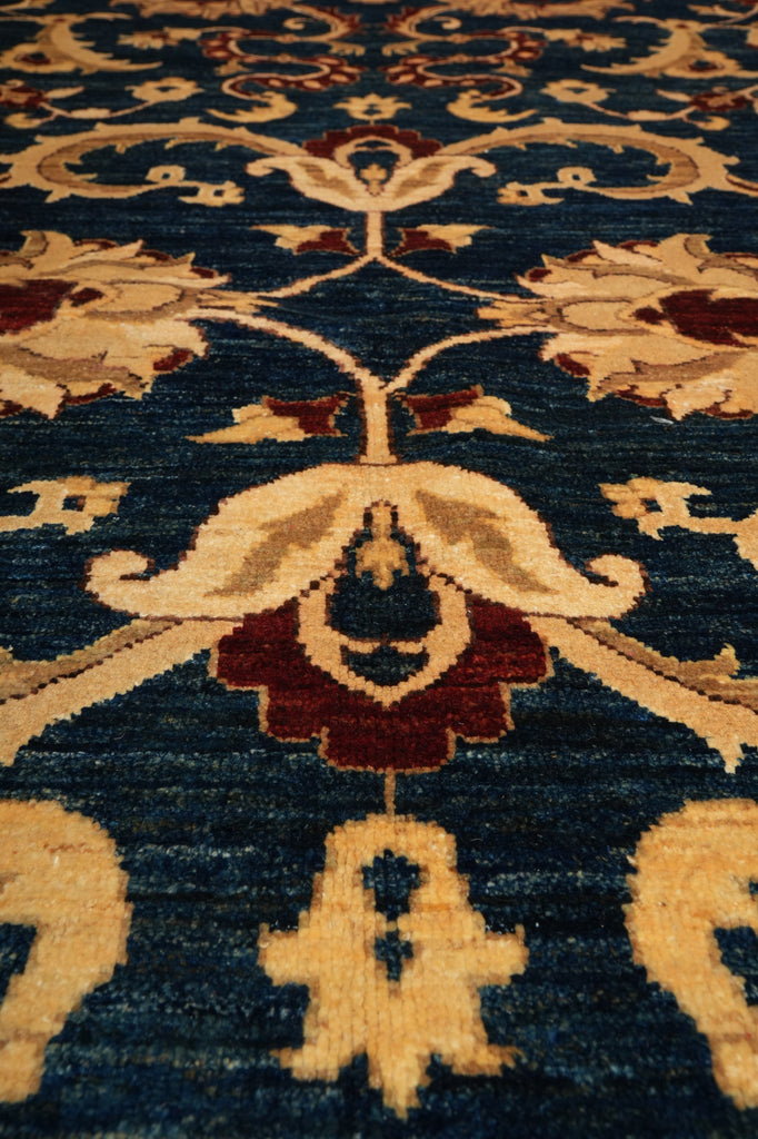 Close-up of a patterned rug with intricate designs on a dark blue background.