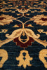 Load image into Gallery viewer, Close-up of a patterned rug with intricate designs on a dark blue background.