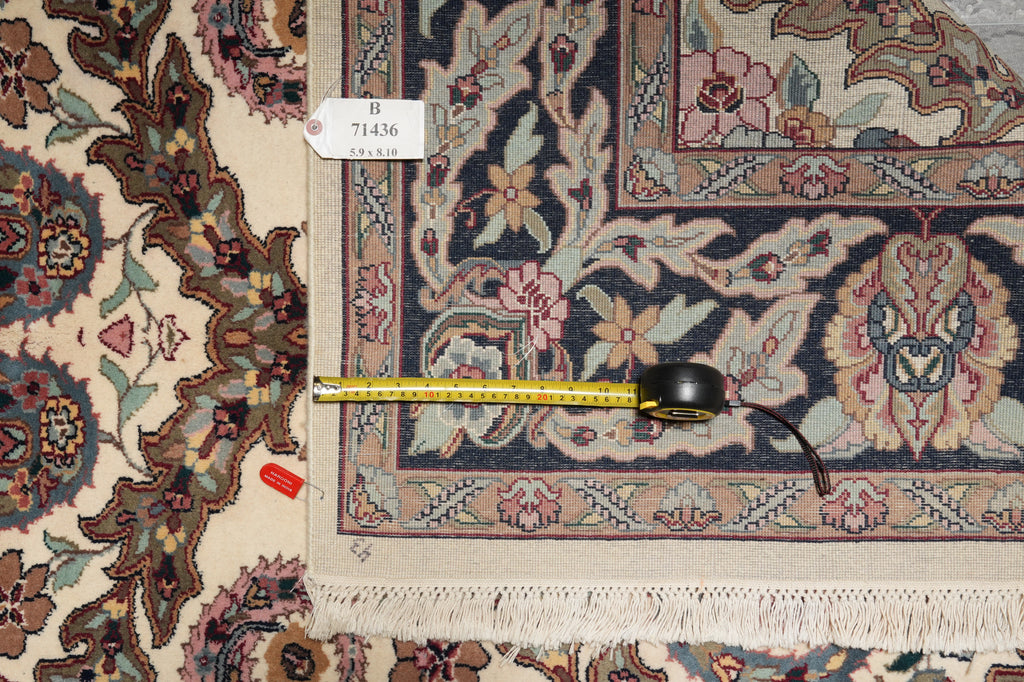Decorative rug with a measuring tape on top, showing dimensions.