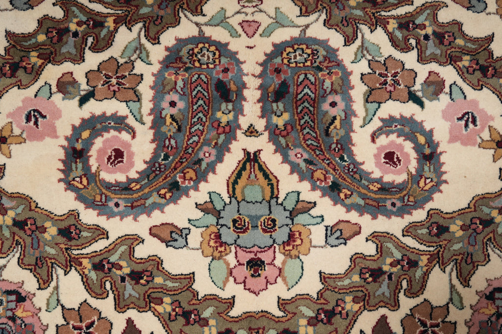 Close-up of a patterned rug with intricate designs and colors.