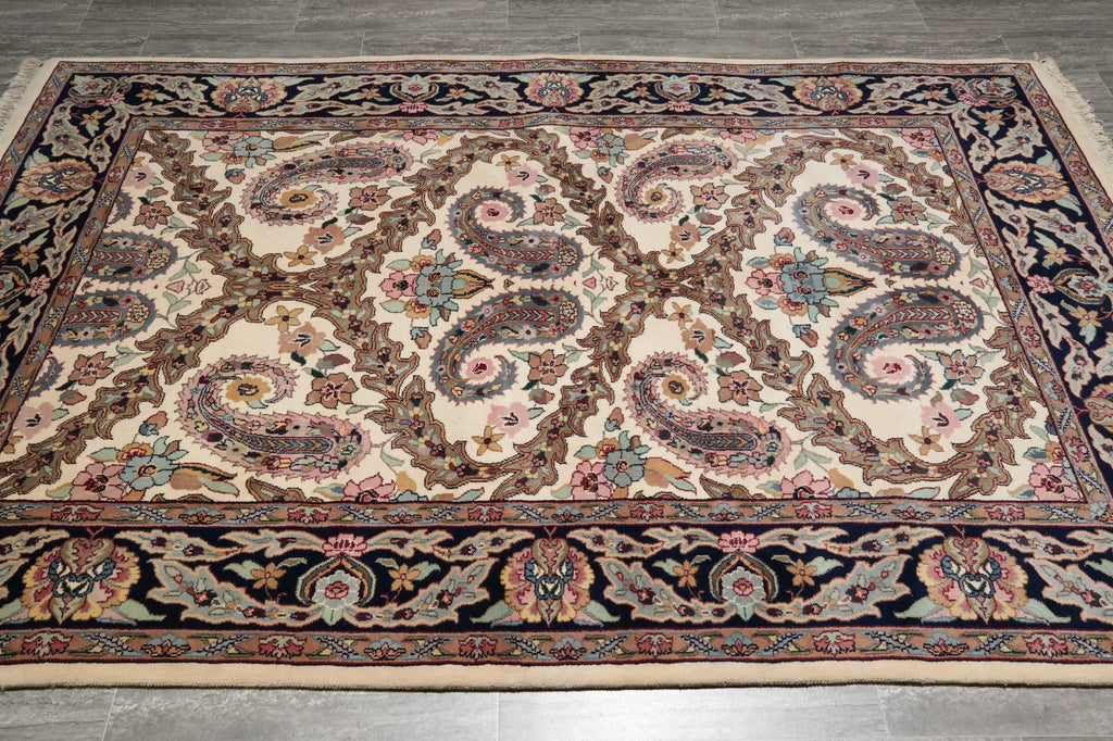 Decorative rug with intricate paisley pattern on a wooden floor