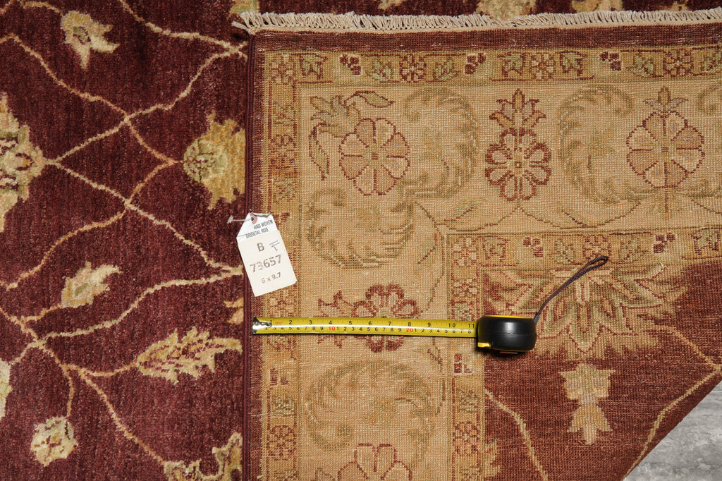 Decorative rug with a measuring tape on top, showing dimensions.