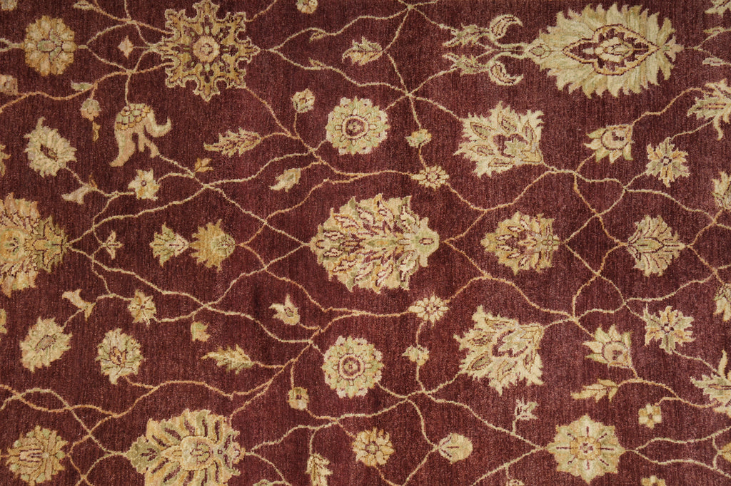 Close-up of a patterned fabric with intricate designs on a brown background
