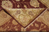 Load image into Gallery viewer, Close-up of a patterned rug with floral designs in brown and beige tones.