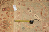 Load image into Gallery viewer, Decorative rug with a tape measure for scale on a floral patterned background